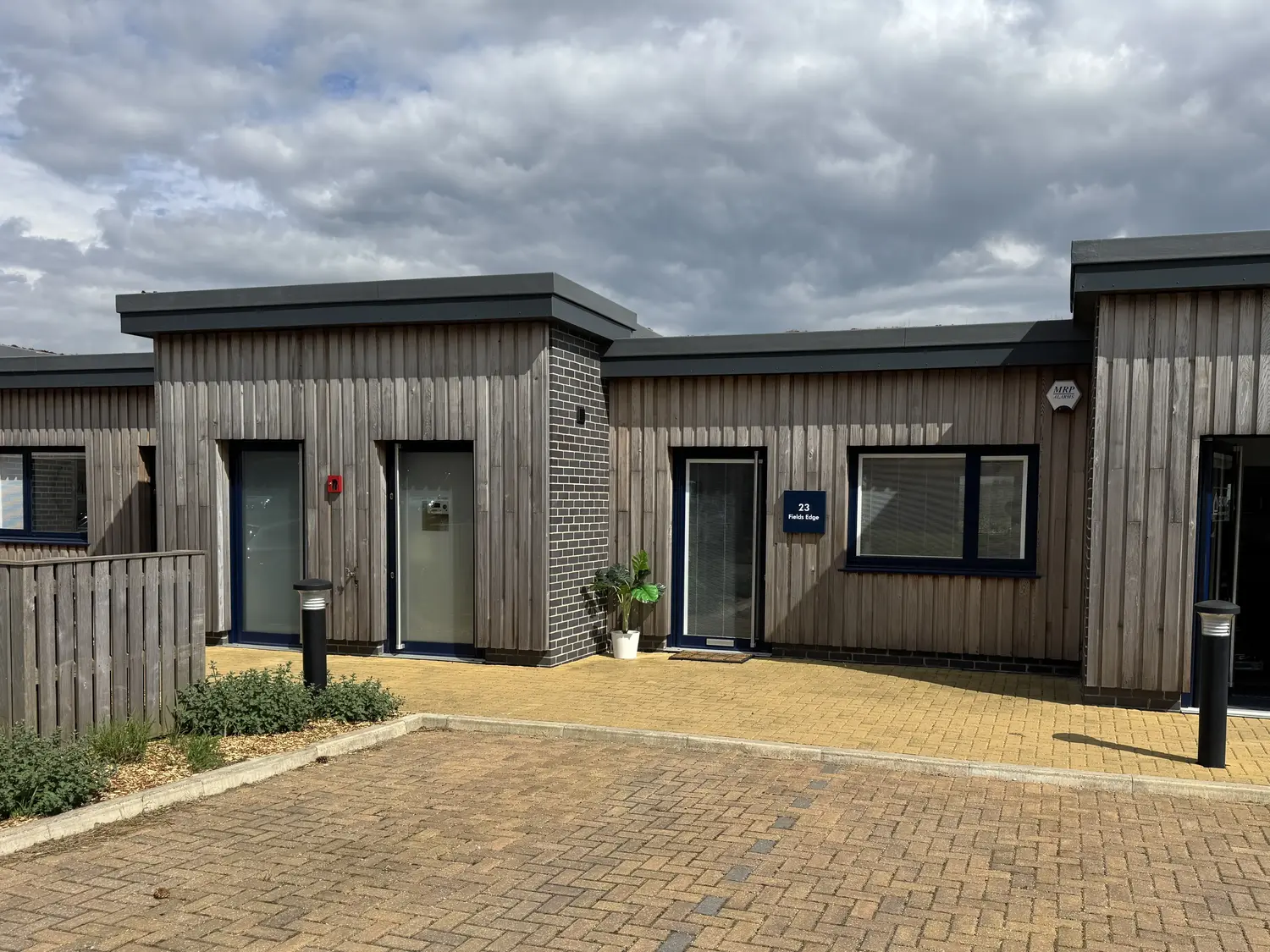 Fields Edge Office Unit 23 from the car park in front. Shows the units to either side, some of the planting and car park landscaping to the front.